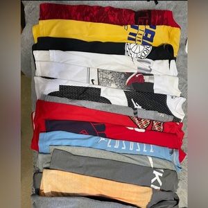 Lot of 13 YL UA, Jordan and Nike shirts.